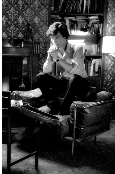 Benedict Cumberbatch as a modern Sherlock Holmes sitting in 221b Baker Street (BBC Sherlock)